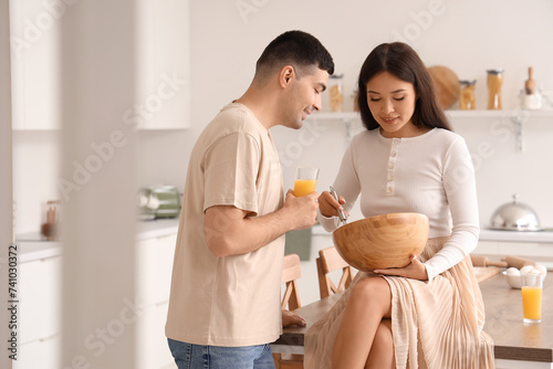 Happy young couple cooking ...