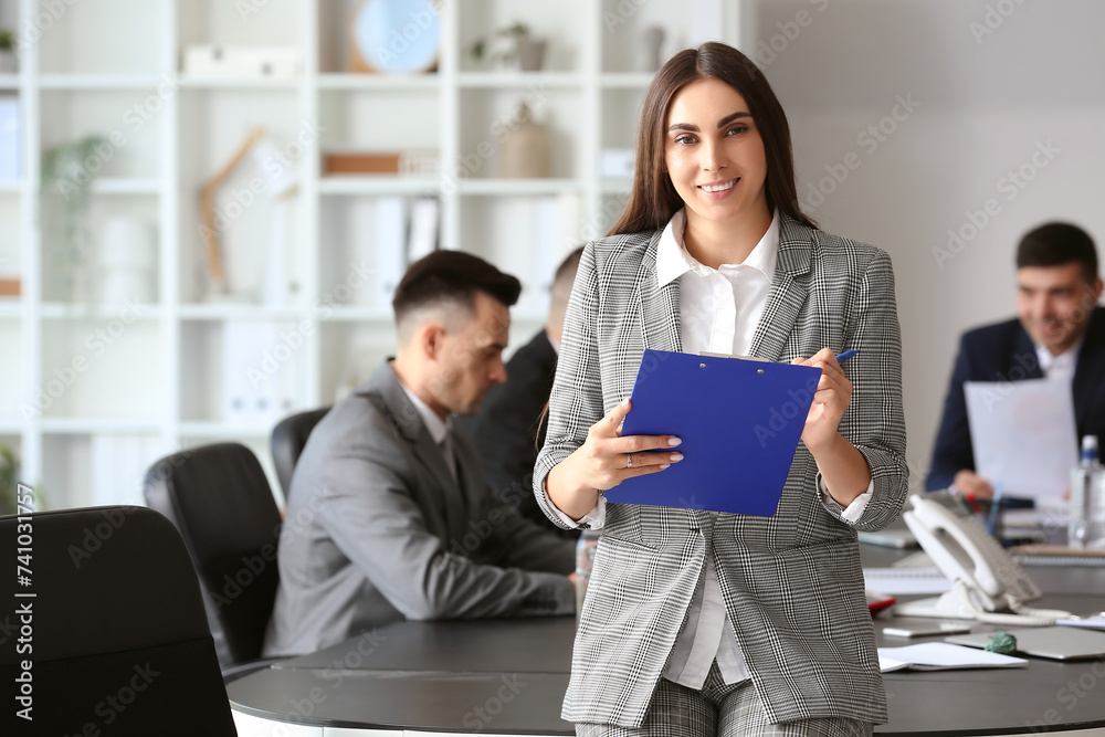 Businesswoman with clipboard in conference hall Businesswoman with clipboard in conference hall