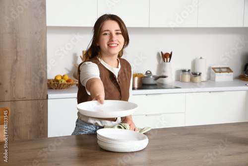 Smiling young woman setting...