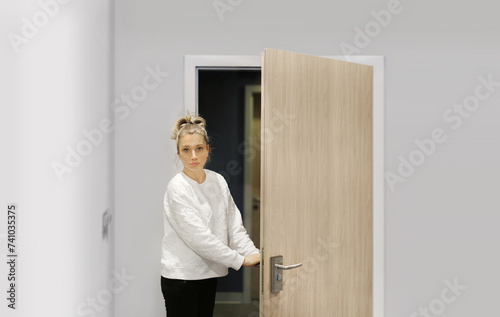 woman opening the door of her home.