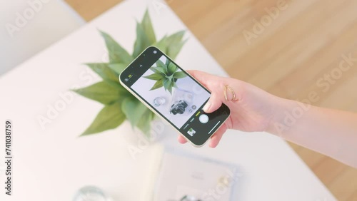 phone in hand taking photo of modern aesthetic flaylay for social media