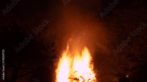 Bonfire with flames illuminating the surroundings. The image captures the practical elements of a bonfire scene, suitable for various purposes