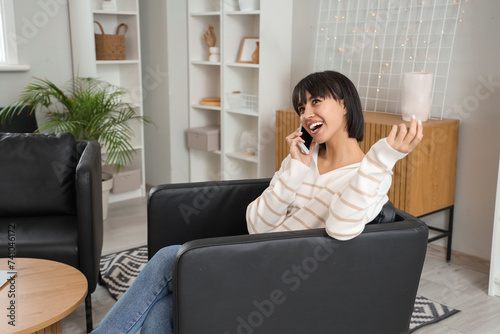 Young woman talking by mobi...