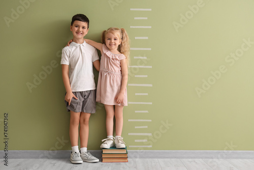 Cute little kids measuring ...