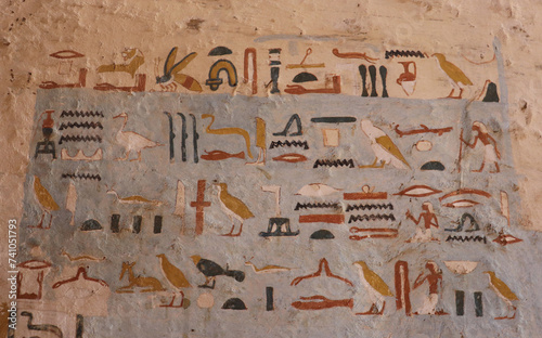 colorful ancient egyptian hieroglyphs at tombs of the Nobles in Aswan, Egypt