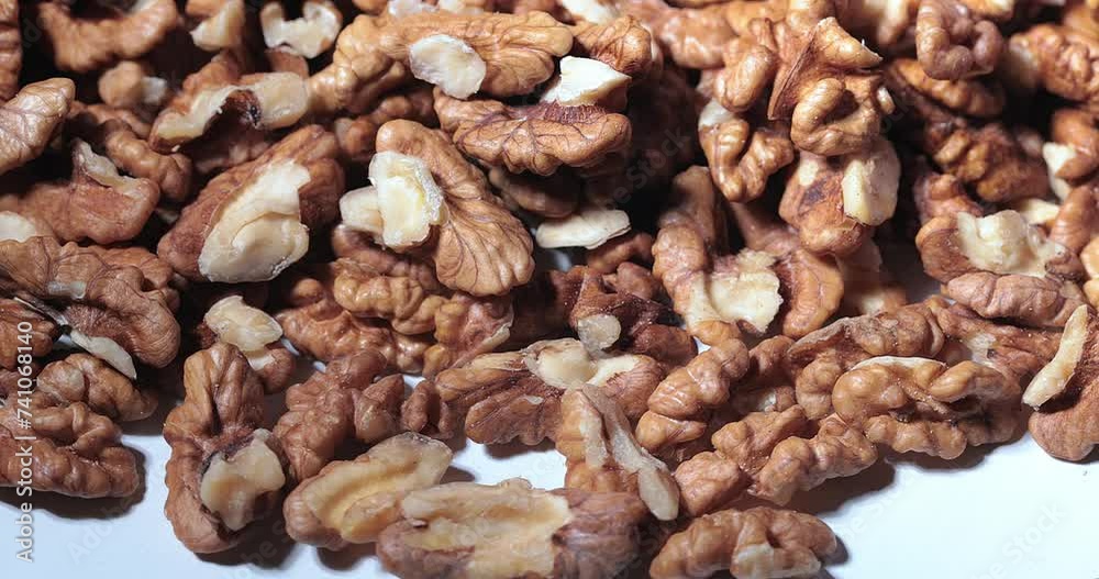 Walnut close up.product with minerals and vitamins, walnut turns in a table Walnut close up.product with minerals and vitamins, walnut turns in a table