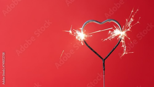 4K video Valentine's Day heart shape sparkler with a red background during the month of February where people get engaged to get married.