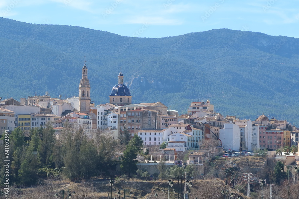 Alcoy, Alicante, Spain, February 20, 2024: Bell tower and dome of the Parish of Santa Maria with the forest in the background. Alcoy, Alicante, Spain
