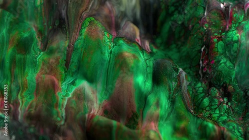 Vibrant, colorful, fluid and wavy abstract paint seamless loop animation. Modern and contemporary style in 4K with shades of green, black, red