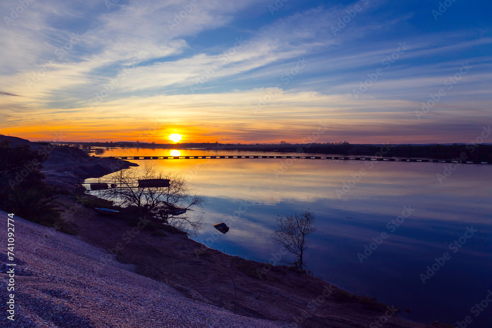 Obraz premium Beautiful winter sunset in the river. Riverscape sunset. Sunset at Tagus River, in the portuguese village of Chamusca
