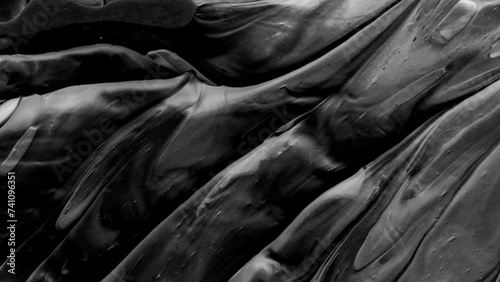 Vibrant, colorful, fluid and wavy abstract paint seamless loop animation. Modern and contemporary style in 4K with shades of black, white, gray