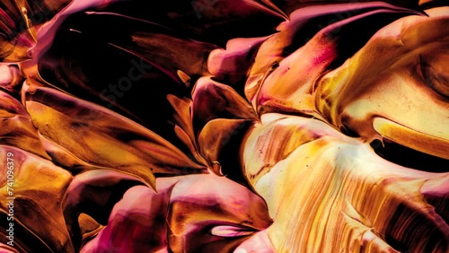 Vibrant, colorful, fluid and wavy abstract paint seamless loop animation. Modern and contemporary style in 4K with shades of yellow, orange, black, red, pink