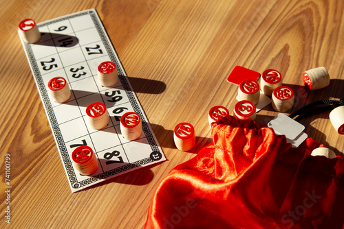 Classic Bingo Game with Wooden Numbers in Sunlight. photo