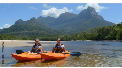 Happy couple enjoying kayaking adventure on vacation in the picturesque river or sea scenery