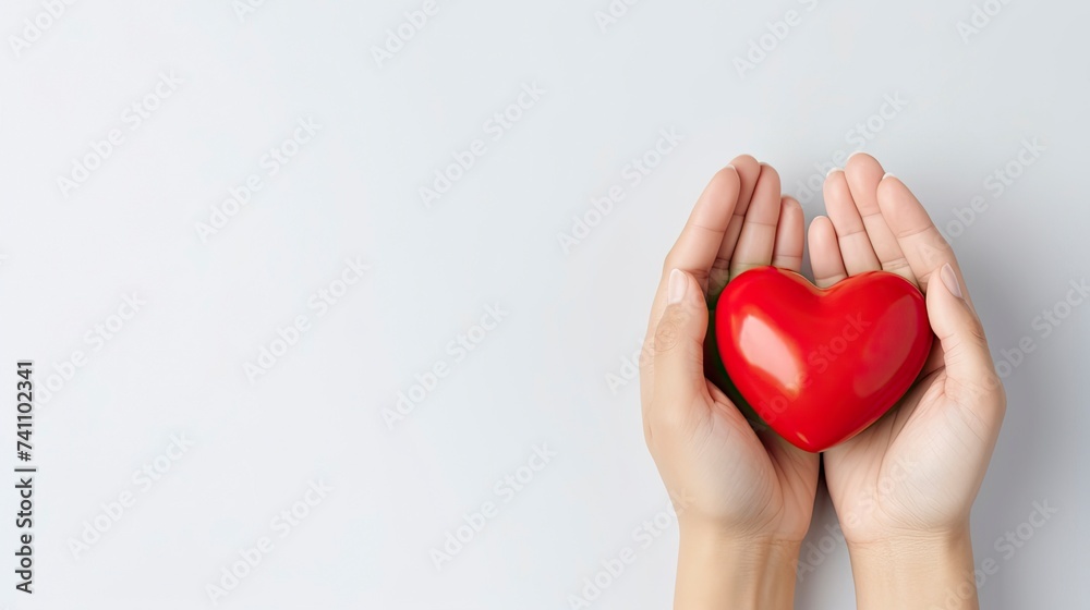 Woman doctor hands holding red heart on wide white background donate for hospital care concept. Panoramic world heart day and world health day, CSR community. copy space - generative ai Woman doctor hands holding red heart on wide white background donate for hospital care concept. Panoramic world heart day and world health day, CSR community. copy space - generative ai