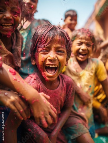 Happy people celebrating holi. the child laughs and throws paint and multi-colored powder. holy holiday in india
