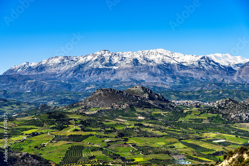 Unique aerial panorama of Profitis Ilias rural region real world landscape  at the footsteps of Psiloritis Mountains range. Olivetree groves  green meadows  vineyards  hills  Heraklion  Crete  Greece.
