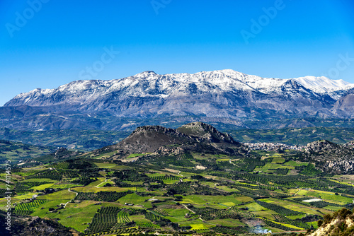Unique aerial panorama of Profitis Ilias rural region real world landscape, at the footsteps of Psiloritis Mountains range. Olivetree groves, green meadows, vineyards, hills, Heraklion, Crete, Greece.