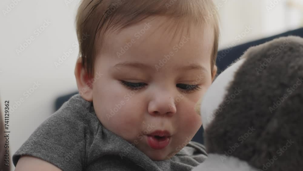 Baby boy playing with a stuffed animal Baby boy playing with a stuffed animal