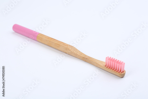 Bamboo toothbrush with pink bristle isolated on white © New Africa