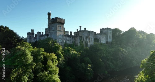 Aerial. Luxury Castle against the backdrop of green trees photo