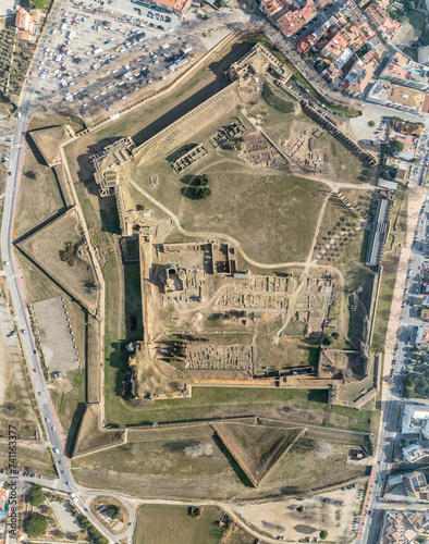 Obraz na płótnie Panoramic aerial view of Roses citadel in Spain , giant pentagonal star fort fortress with bastions on each angle, ruins of medieval city, Roman ruins, monastery on the courtyard w salonie