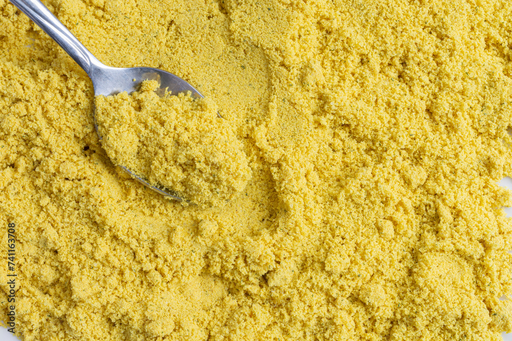 Obraz premium An abstract image of powdered chicken soup stock mixed with spices and metal spoon.