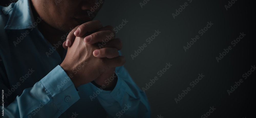 Christian life crisis prayer to god, Man Pray for god blessing to wishing have a better life, Man hands praying to god with the bible, Begging for forgiveness and believe in goodness.