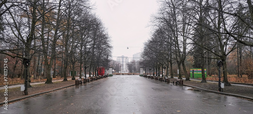 Central alley with benches in Sokolniki Park in Moscow in autumn photo