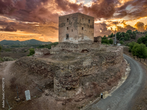 Torres Torres castle medieval hilltop stronghold in Spain with square tower and dramatic sunset sky