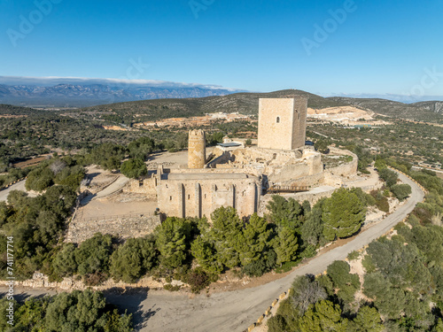 Aerial view of Ulldecona castle, Serra Grossa mountain top, former frontier fortified complex old church, emblematic circular tower and square keep photo