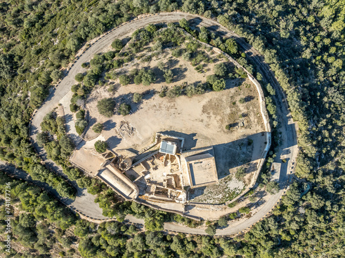 Aerial view of Ulldecona castle, Serra Grossa mountain top, former frontier fortified complex old church, emblematic circular tower and square keep photo