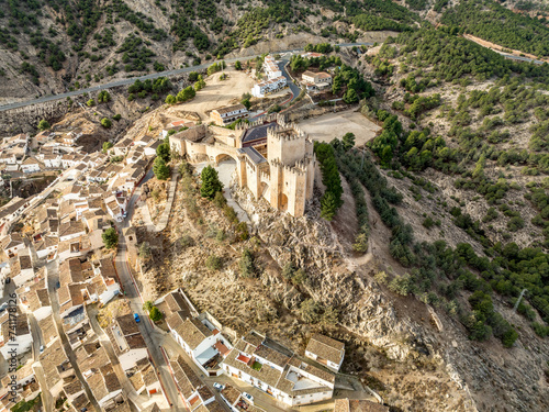 Aerial view of Velez Blanco hilltop medieval castle with square tower, restored Gothic palace above the town with dramatic sky