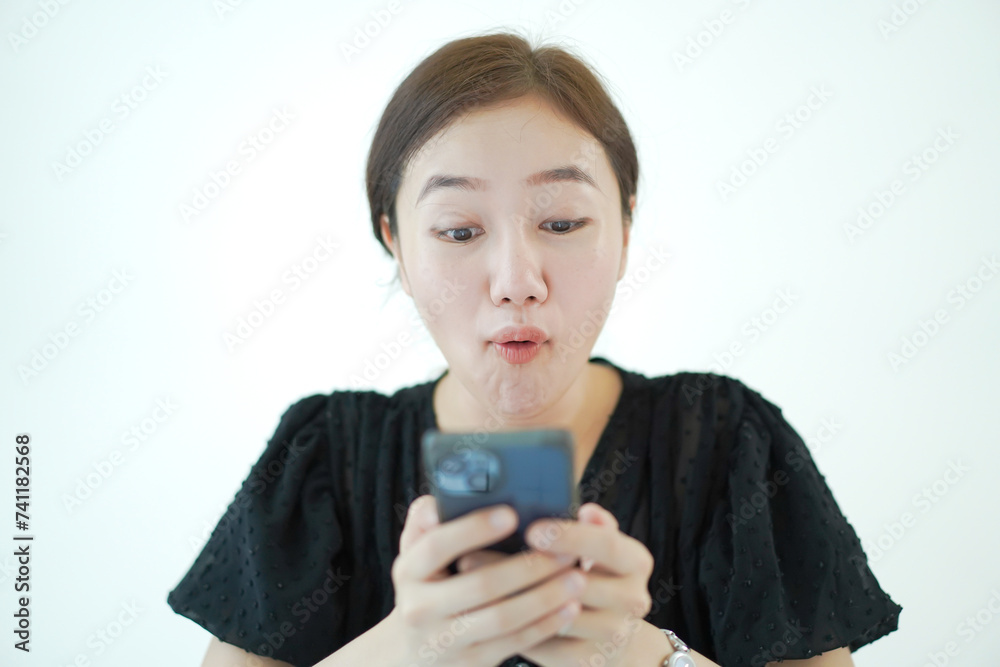 Excited face of Asian young enjoy using mobile phone. Excited face of Asian young enjoy using mobile phone.