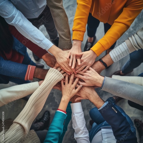 TOverhead view of a diverse group of people showing team spirit and unity by placing their hands together. generative ai 