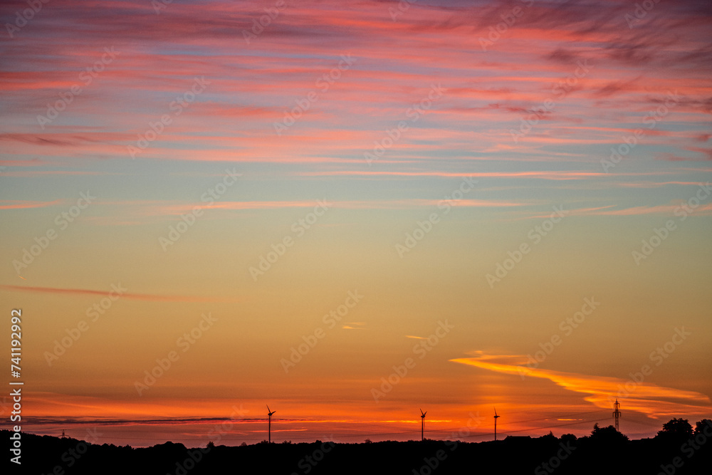 Naklejka premium Colorful sunrise with beautiful veil clouds