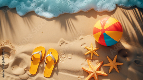 Beach accessories on the sand, top view photo