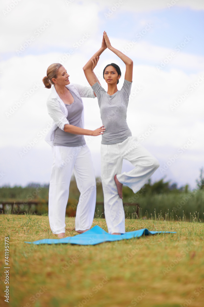 Woman, personal trainer and yoga on field in nature for spiritual wellness, namaste or wellbeing. Young female person, yogi or fitness teacher in zen, balance or stretching on mat in outdoor exercise Woman, personal trainer and yoga on field in nature for spiritual wellness, namaste or wellbeing. Young female person, yogi or fitness teacher in zen, balance or stretching on mat in outdoor exercise