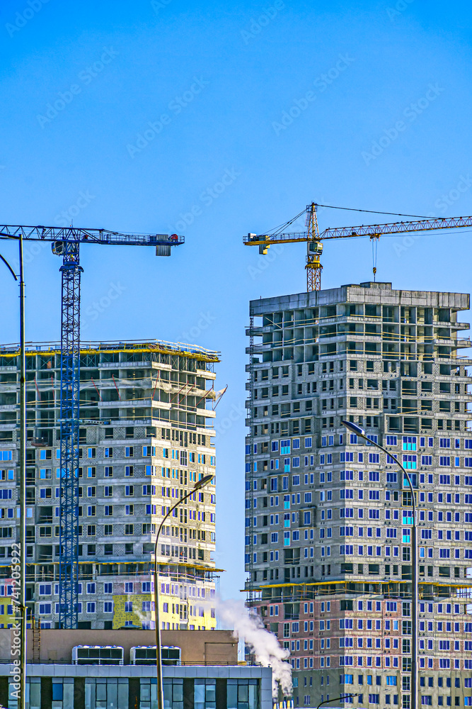 Construction site of multi-storey residential buildings on a winter day Construction site of multi-storey residential buildings on a winter day