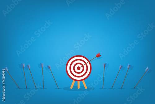 Business challenge failure and success concept. Blue arrows missed hitting target and only red one hits the center.	