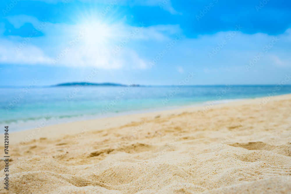 Beach sand for summer vacation concept. Beach nature and summer seawater with sunlight light sandy beach Sparkling sea water contrast with the blue sky.Beach sand for summer vacation concept.
