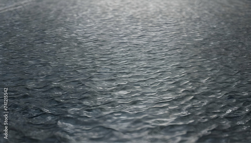 Raindrop above a rippled water surface, reflecting the sky and the clouds. Background illustration.