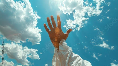 Jesus Christ is clothed in white and reaches out to you in the sky as a symbol of Christianity.