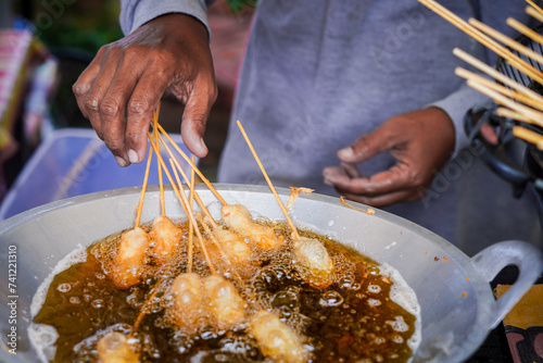 Cilor or Cilung, Indonesian traditional street food being fried. photo