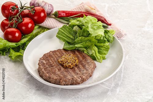 Frilled beef burger cutlet with iceberg