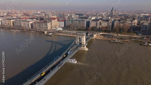 Cityscape with misty horizon seen from the bird eye view on a sunny autumn day, calm waters of the river with moored ships and cruise liners sailing. High quality 4k footage photo