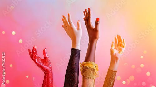 Female hands reaching out for equality and justice against a bright background. Four women's hands of different nationalities and colors are raising up on a vivid bright pink background. photo
