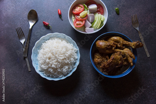 Indian meal steamed rice and chicken curry served. photo