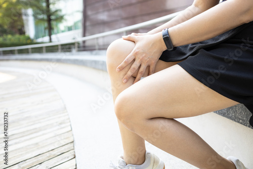Middle aged woman holding knee,pain in kneecap or muscles around knee joint,patella friction against the thigh bone,disease of Runner's knee or Patellofemoral pain syndrome,ligament injury,health care