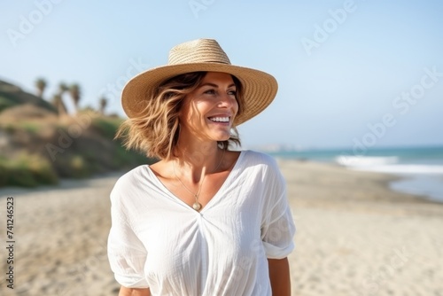 Portrait of a beautiful woman smiling on the beach in summertime